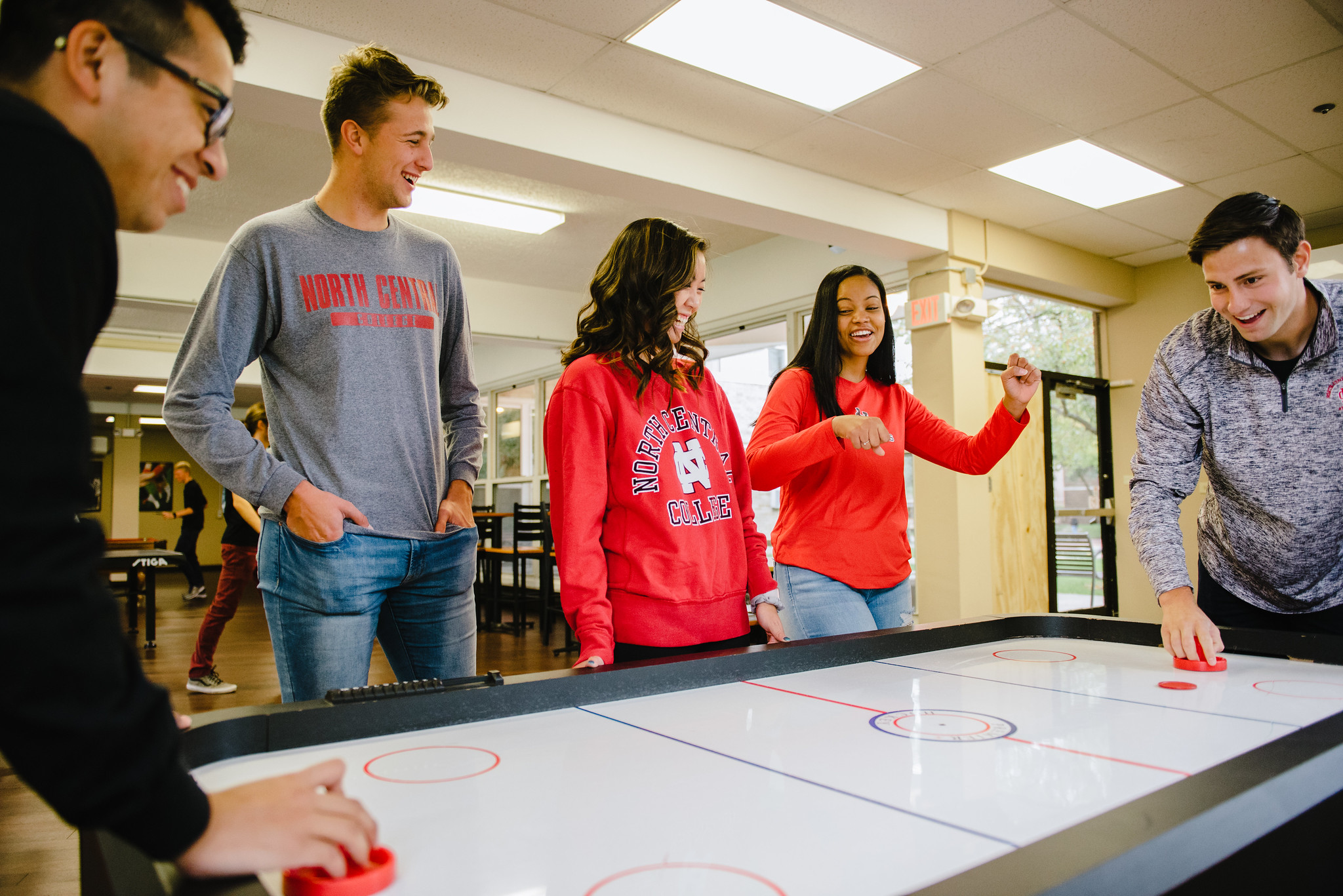 students playing air hockey in dorm lounge