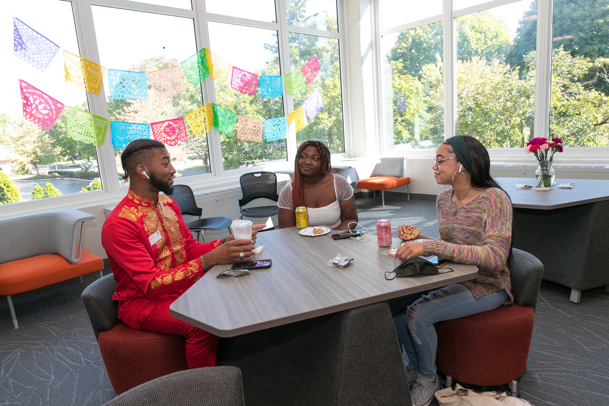 Students sitting around a table in the Multicultural Center
