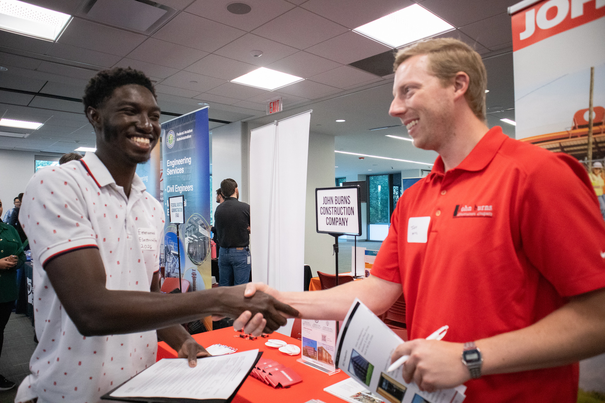 A student and recruiter shaking hands at a career fair