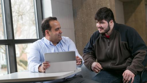 student and professor smiling
