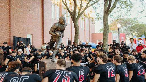 North Central College football players praying before a game.