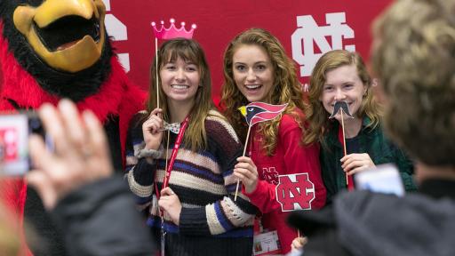 Three students posing at a photo booth during Admitted Student Day