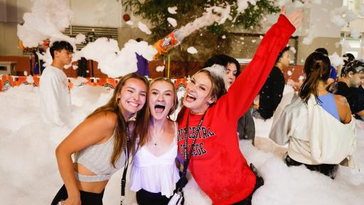 Students posing in front of foam machine