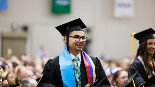 student standing at graduation