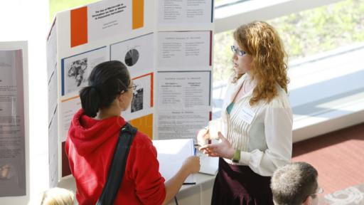 Students discussing a presentation at the annual Rall Symposium.