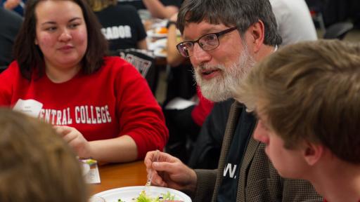 Professor Karl Kelley talking to students at a Cardinal First event.
